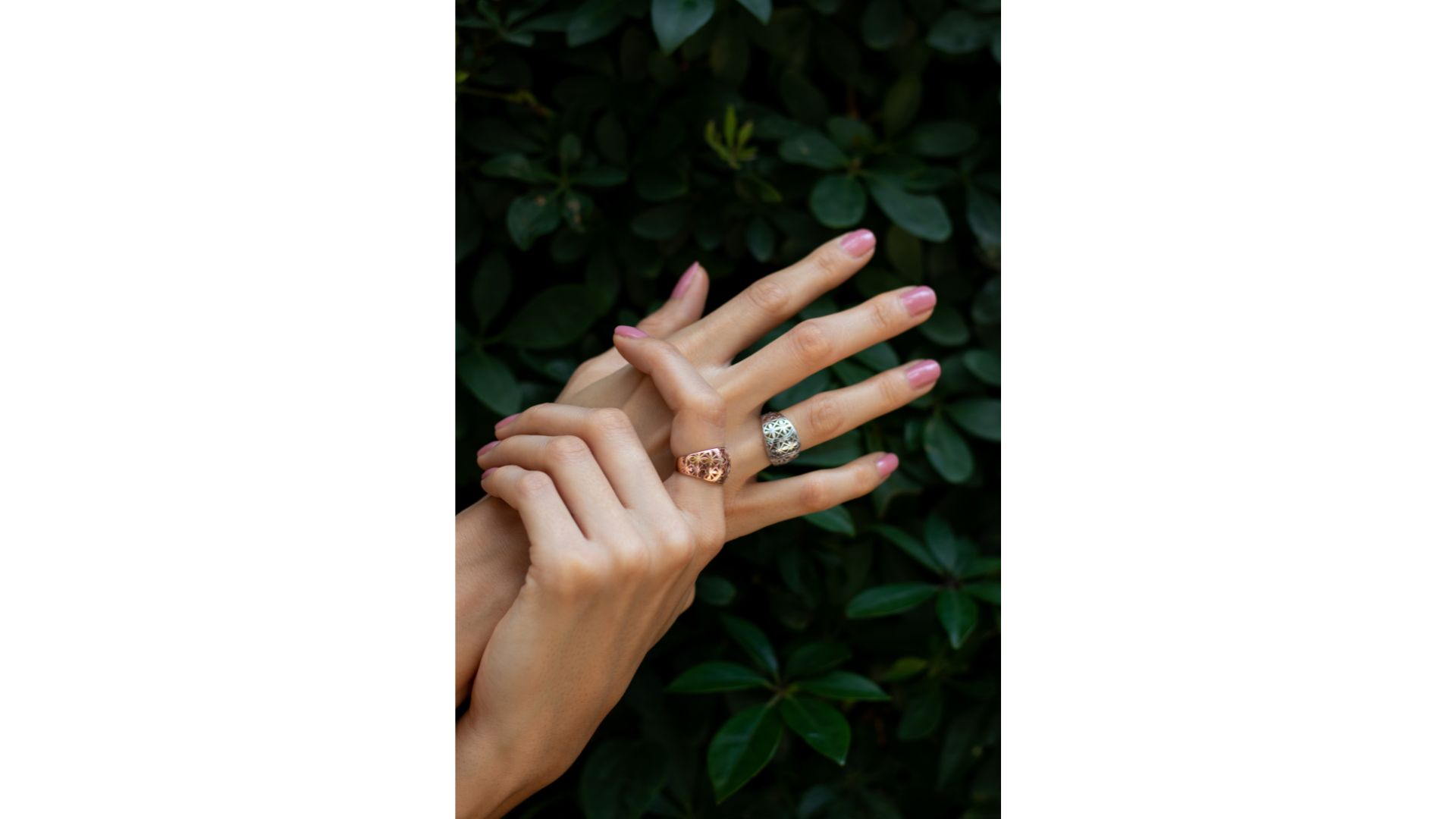 A close up of hands with rings

Description automatically generated