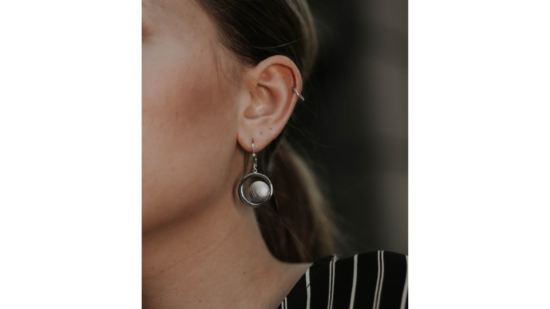 A close-up of a person's ear

AI-generated content may be incorrect.