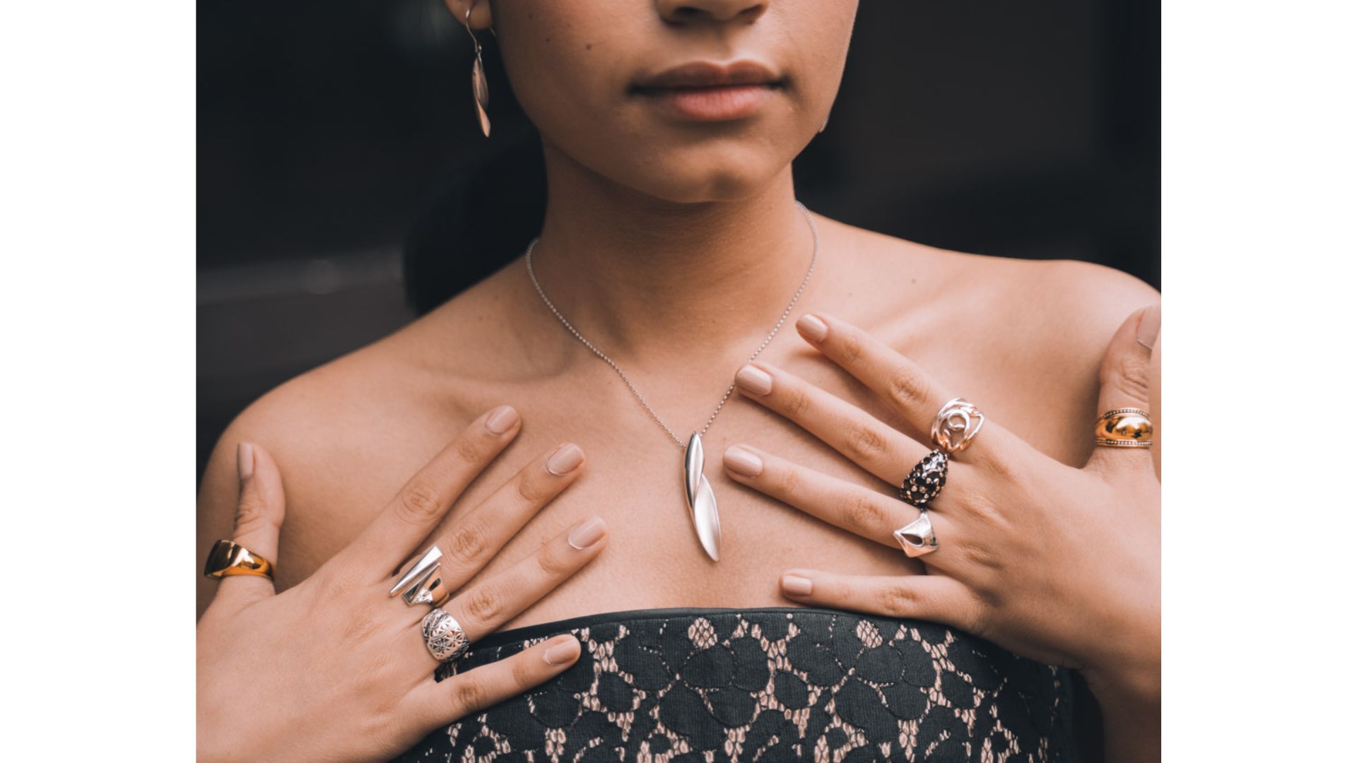 A person with her hands on her chest

Description automatically generated