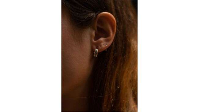 A close-up of a person's ear

Description automatically generated