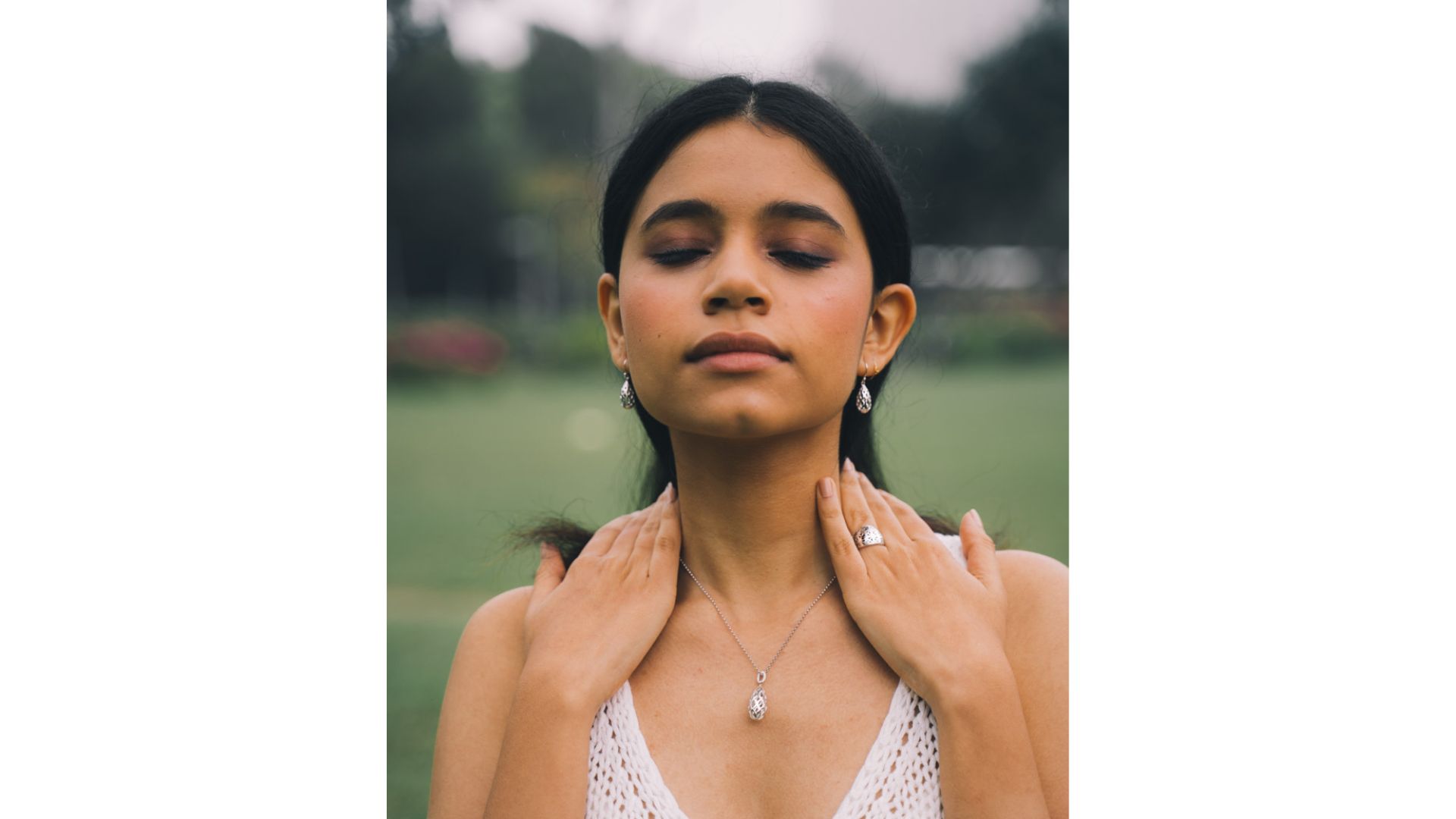 A person with her eyes closed
Description automatically generated