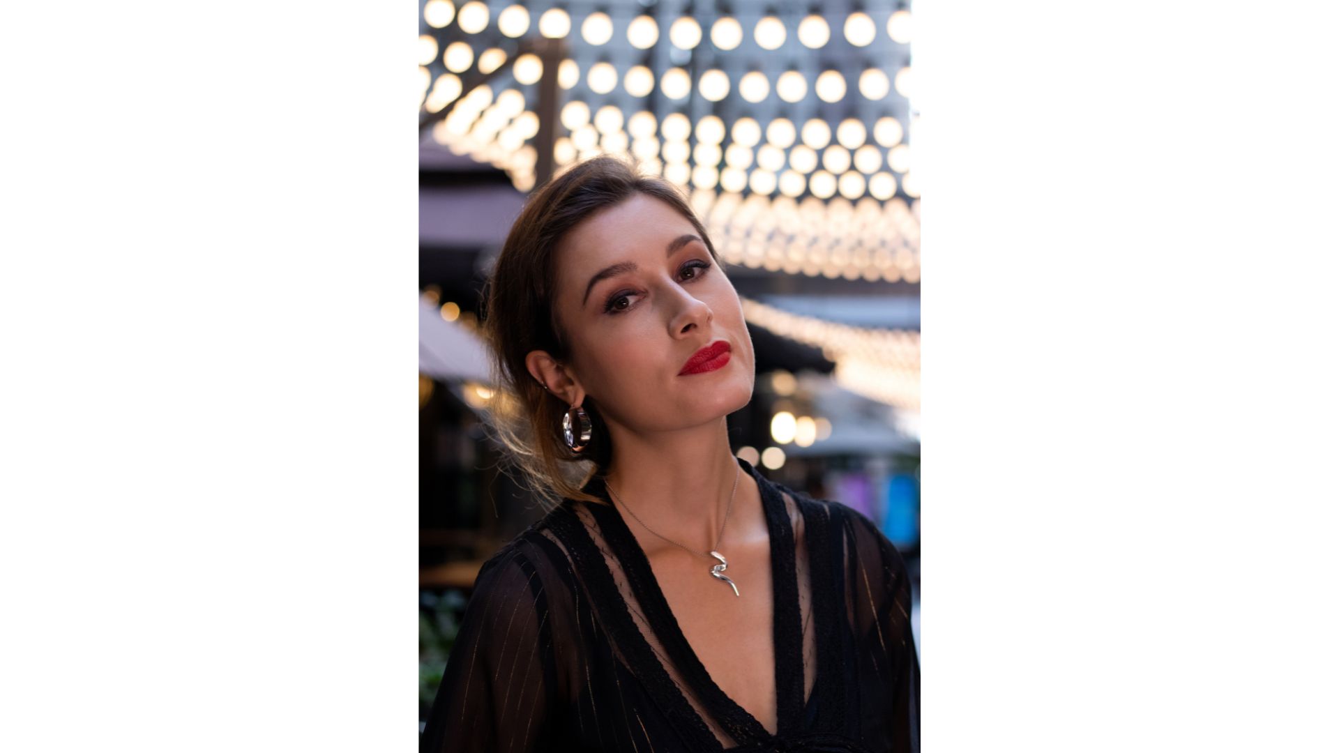 A person in a black dress
Description automatically generated