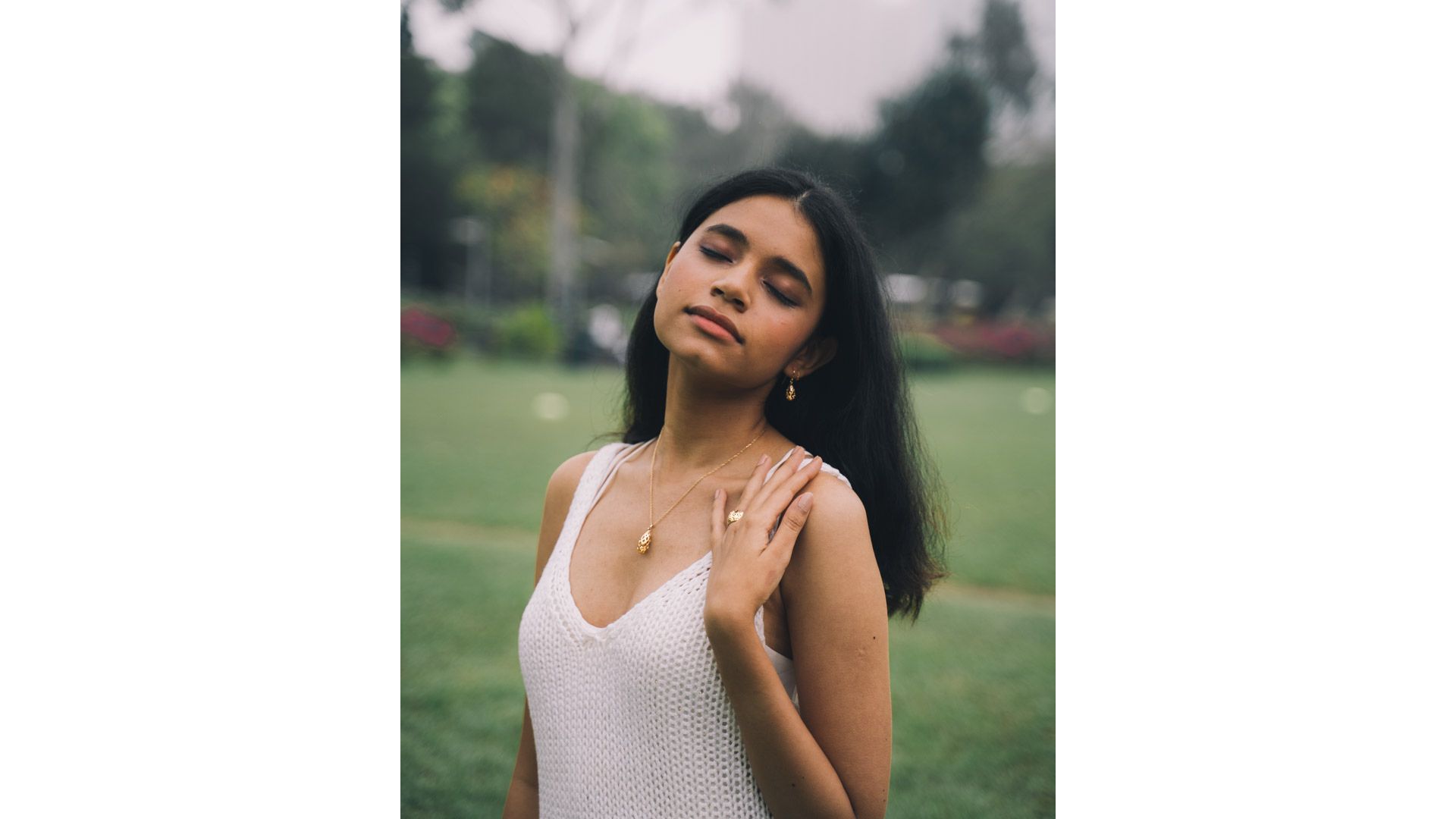 A person with her eyes closed
Description automatically generated