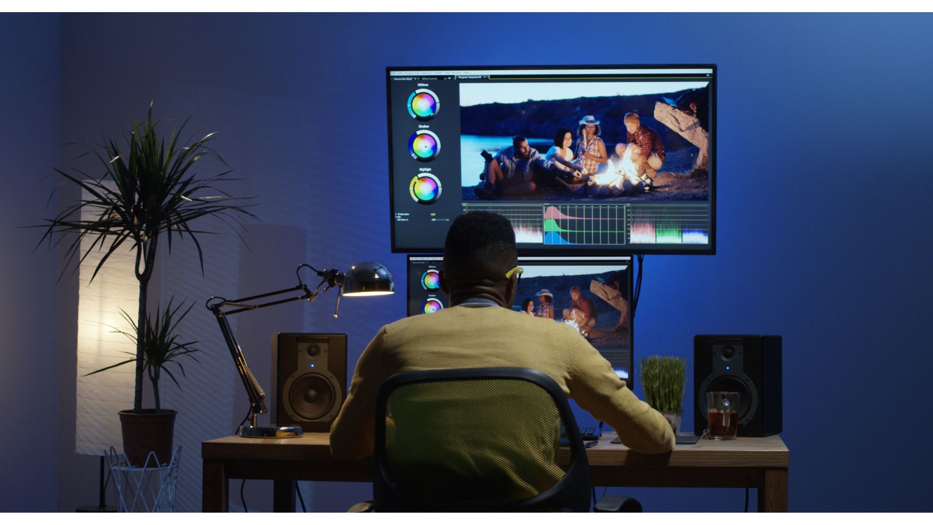 A person sitting at a desk looking at a computer screenundefinedundefinedundefinedundefinedDescription automatically generated