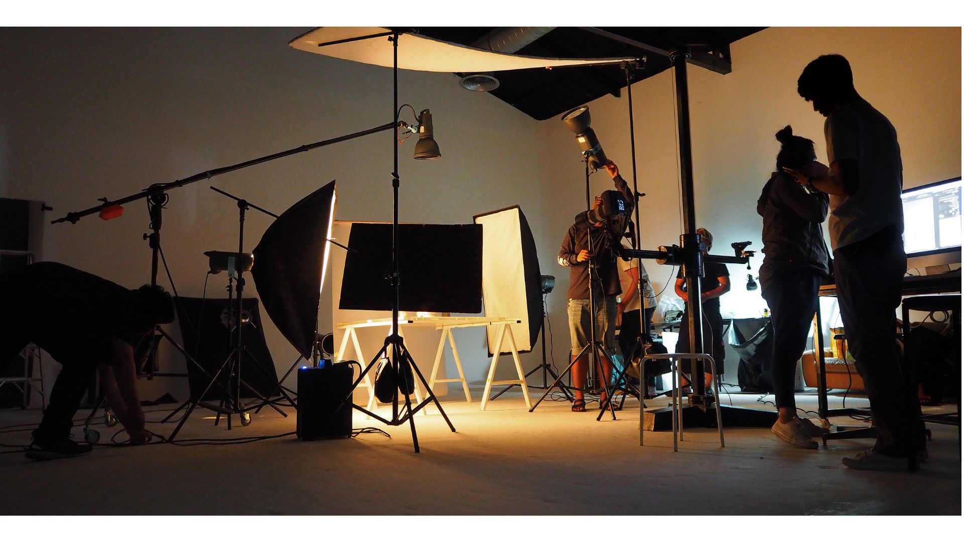 A group of people in a photo studioundefinedundefinedundefinedundefinedDescription automatically generated