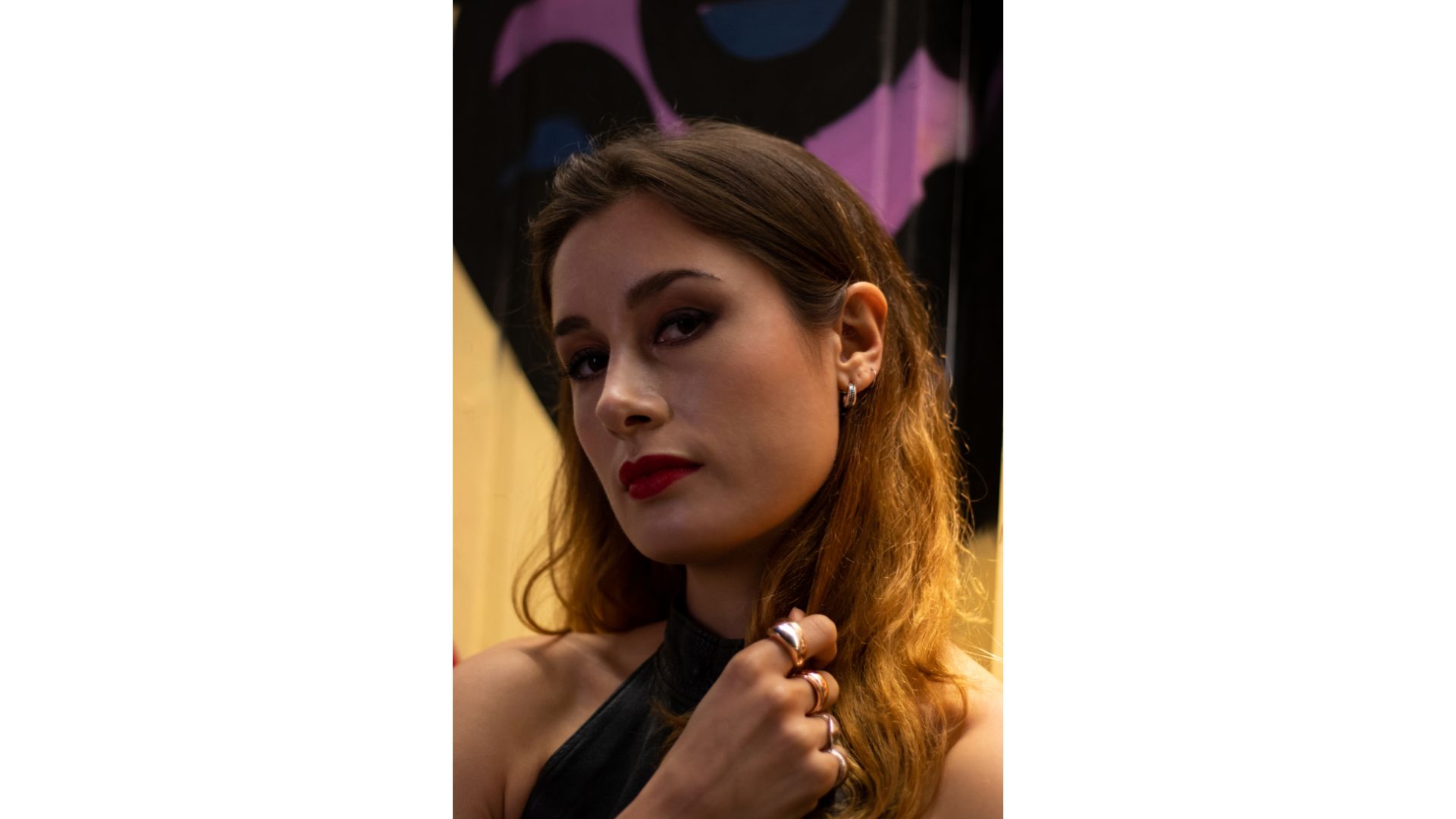 A person with long hair and red lipstick

Description automatically generated