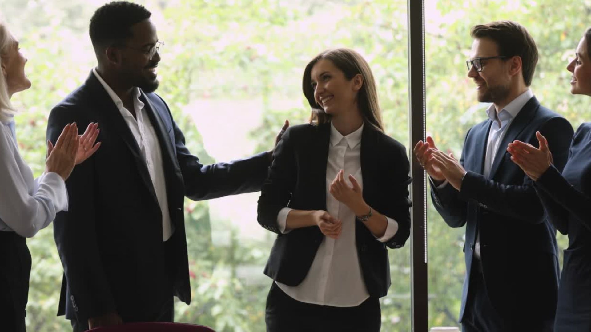 A group of people standing in front of a windowundefinedundefinedundefinedundefinedAI-generated content may be incorrect.