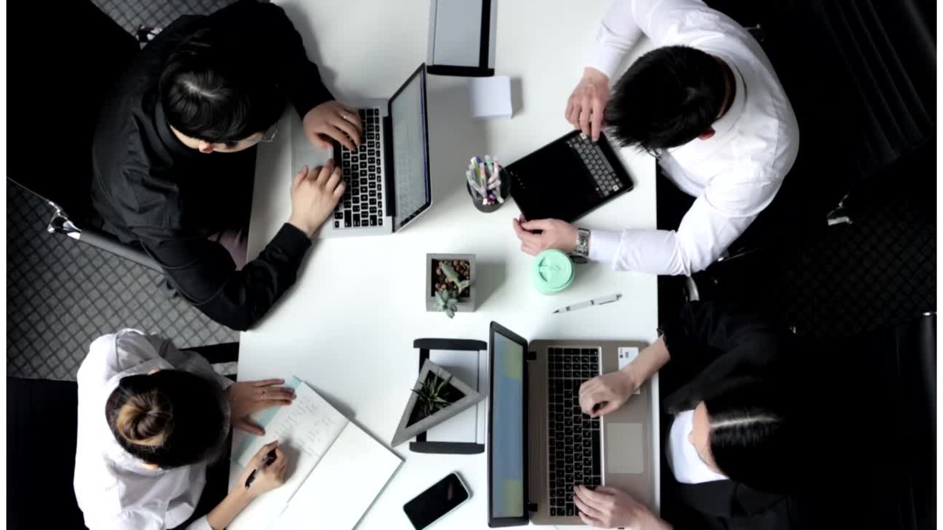 A group of people working on laptopsundefinedundefinedundefinedundefinedAI-generated content may be incorrect.