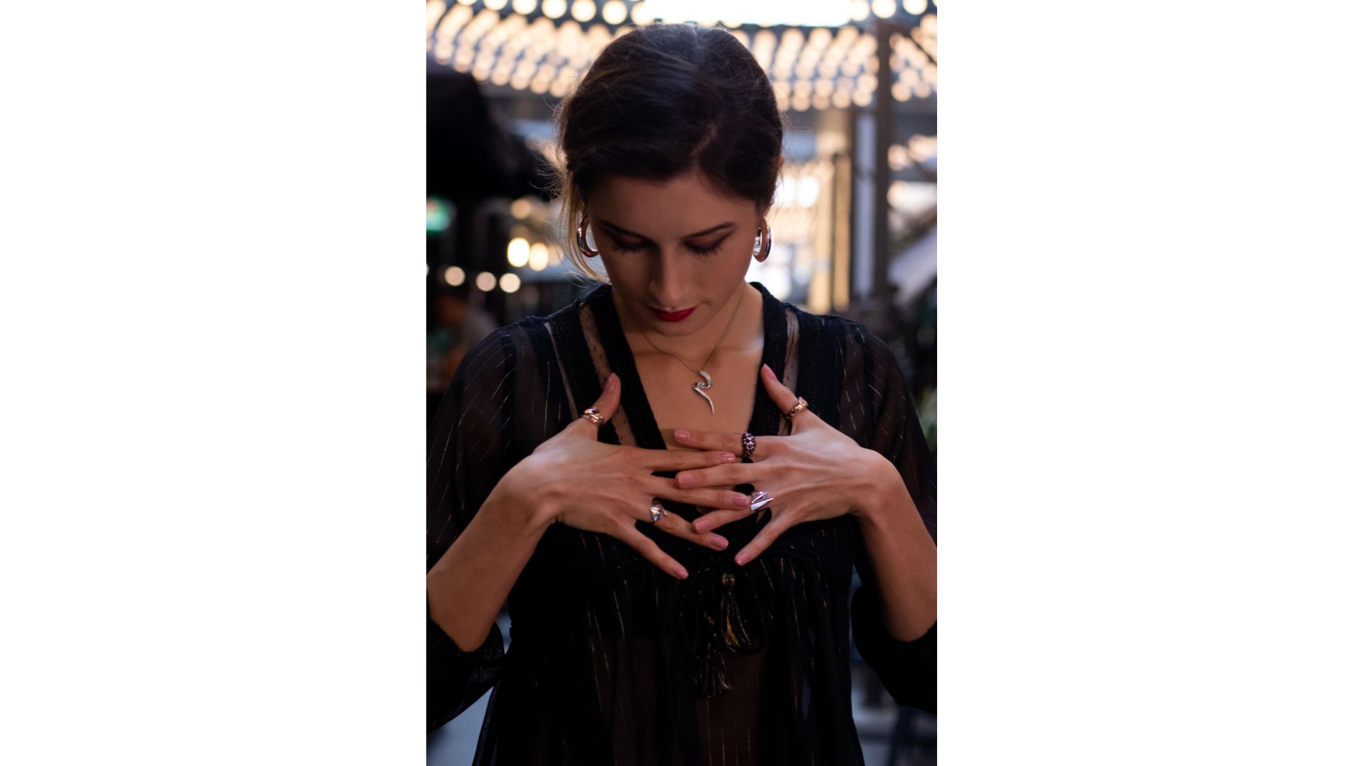 A person with her hands on her chest
Description automatically generated