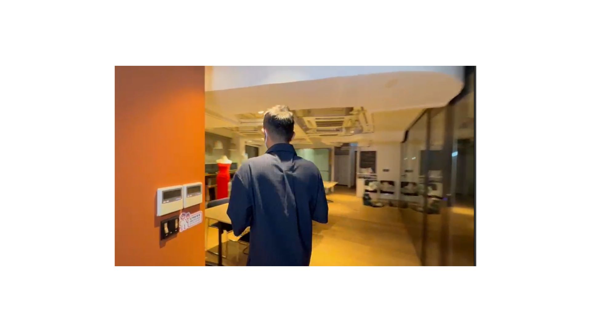 A person standing in a room
Description automatically generated