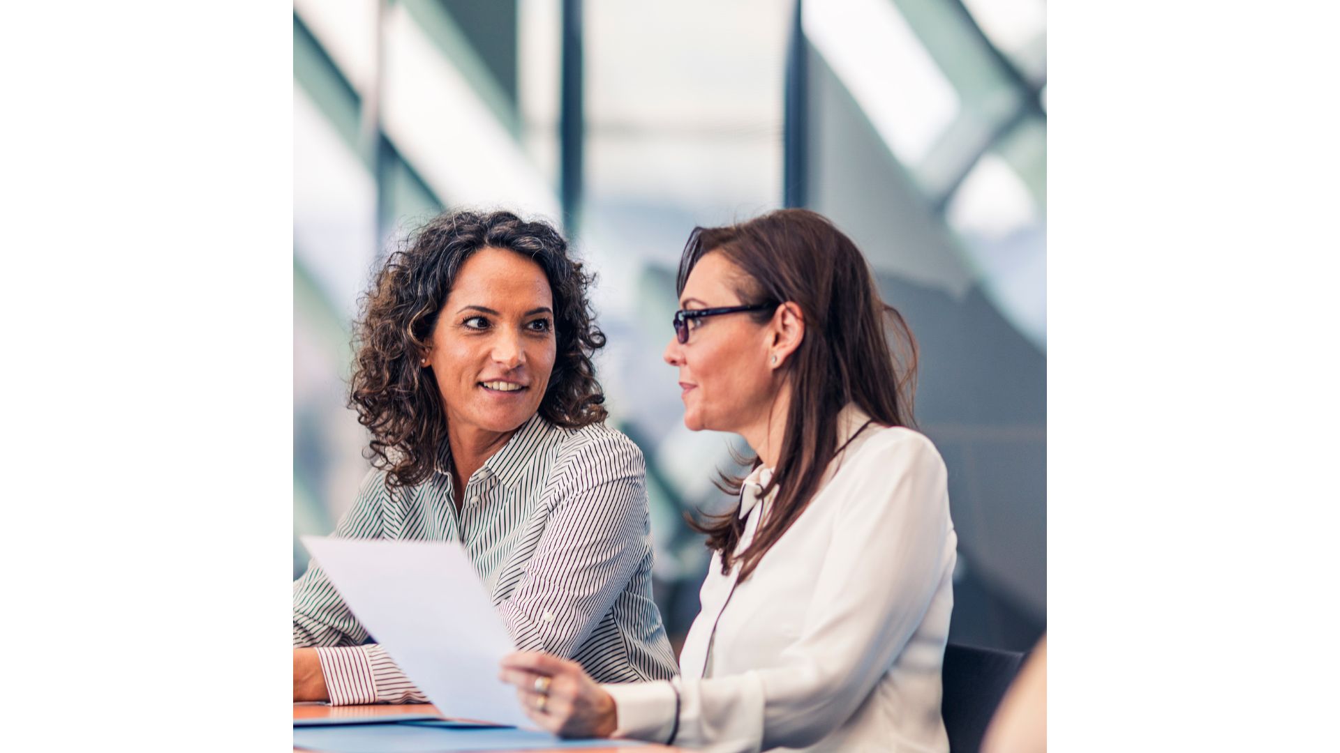A couple of women sitting at a table looking at a piece of paper

AI-generated content may be incorrect.