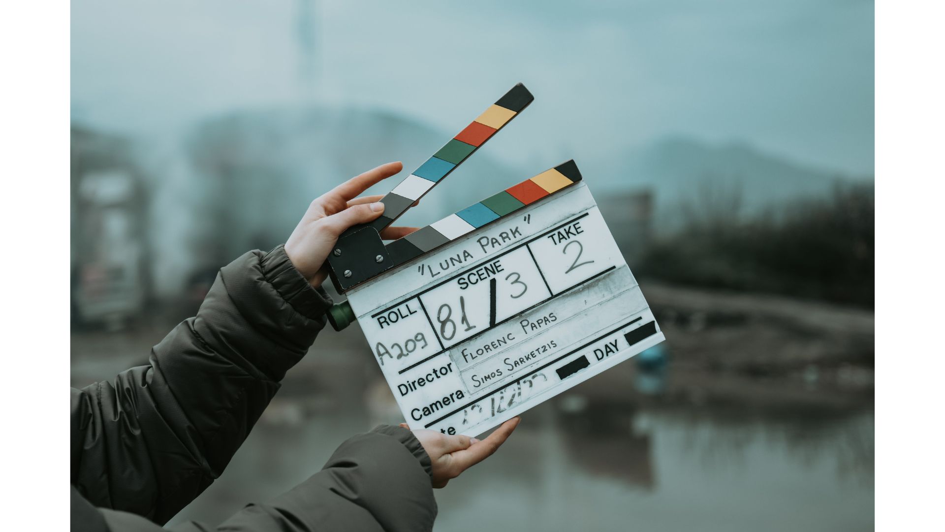 A person holding a movie clapper boardundefinedundefinedundefinedundefinedAI-generated content may be incorrect.