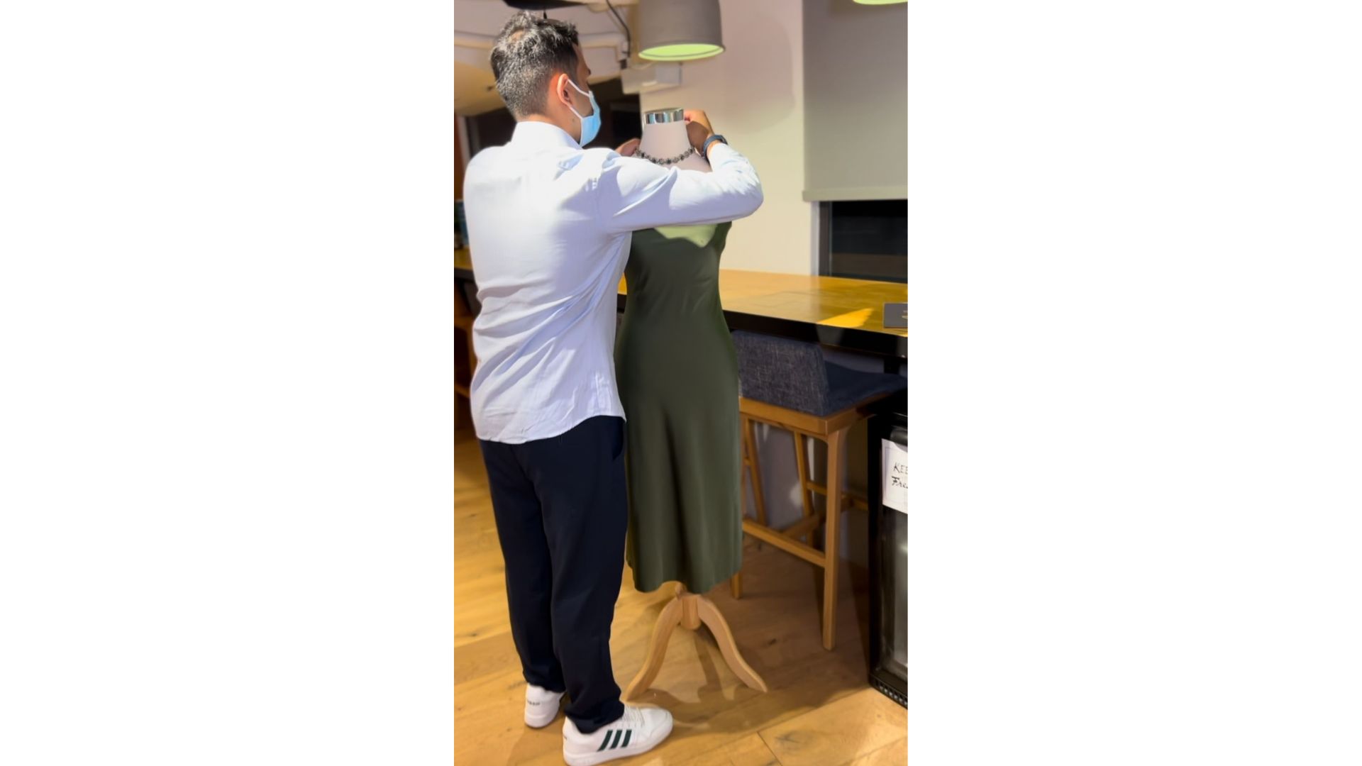 A person wearing a mask and standing next to a mannequin
AI-generated content may be incorrect.