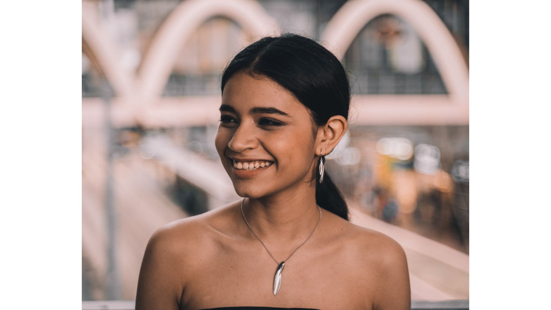 A person smiling at the camera

Description automatically generated