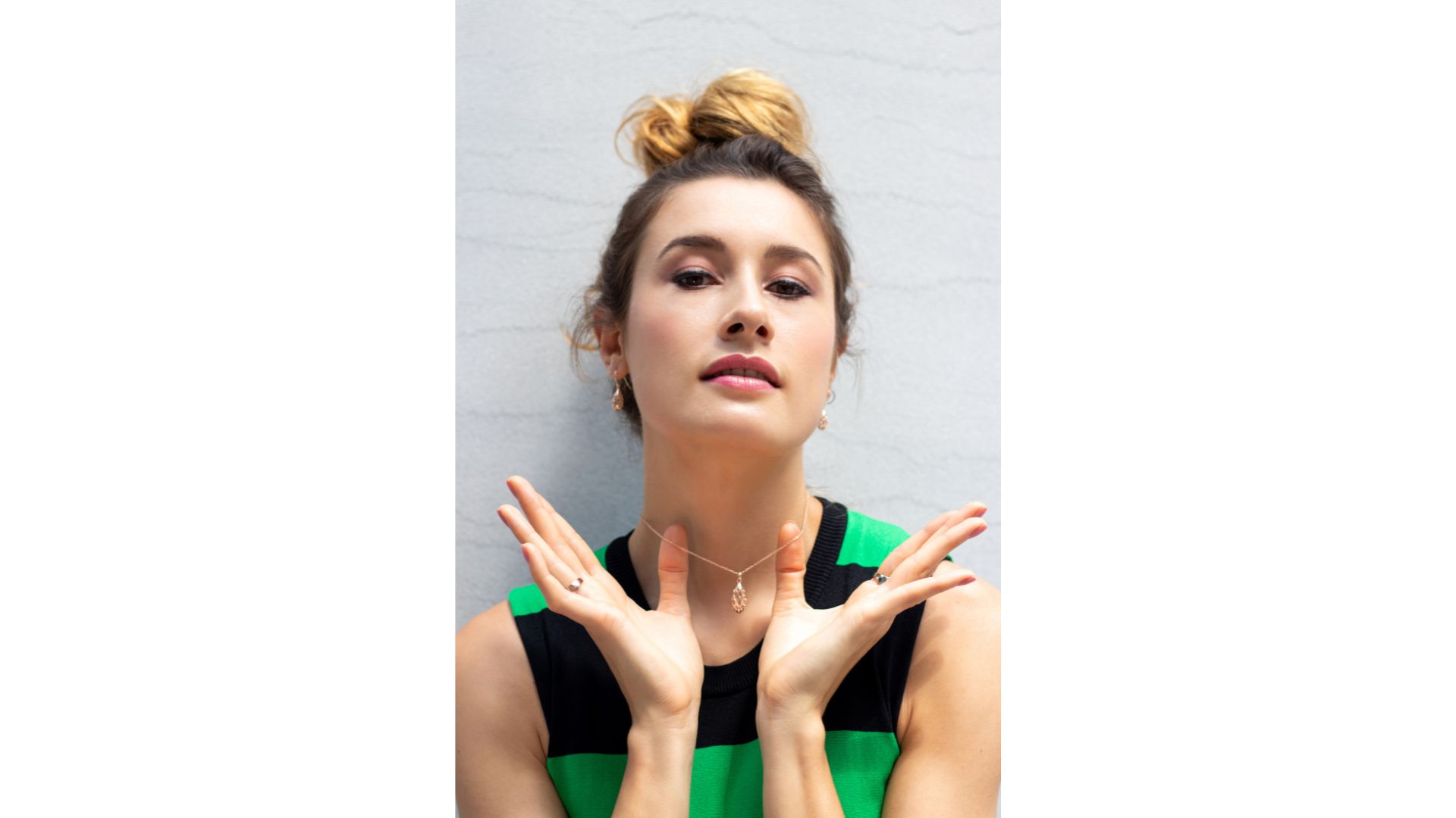 A person with her hands up
Description automatically generated