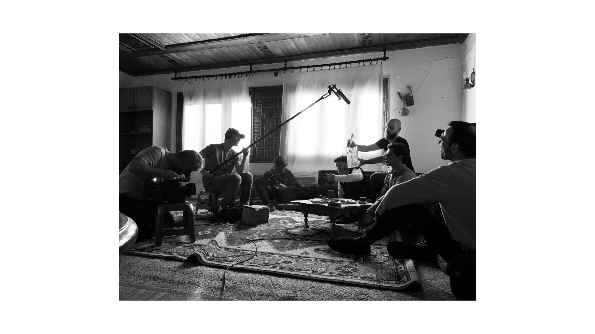 A group of people sitting in a room
AI-generated content may be incorrect.