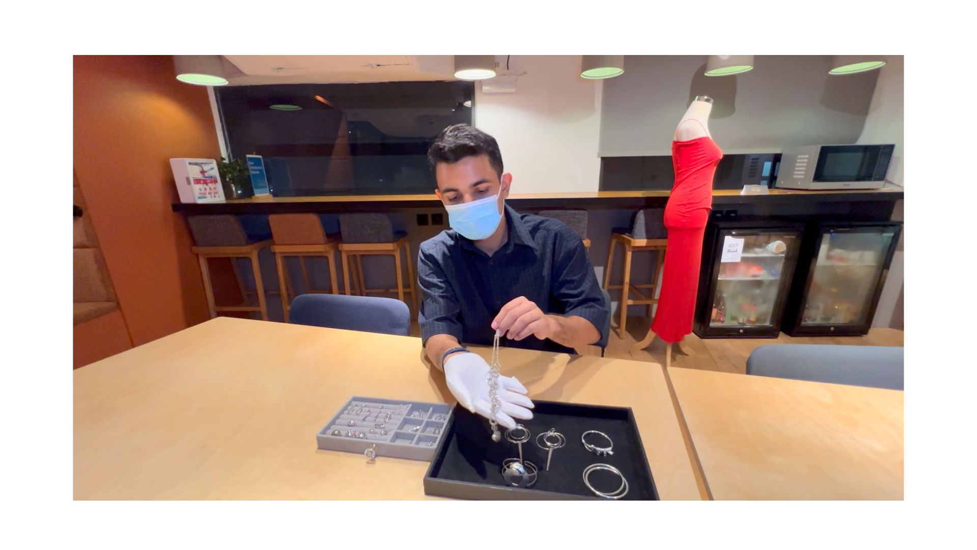 A person wearing a mask and gloves

AI-generated content may be incorrect.