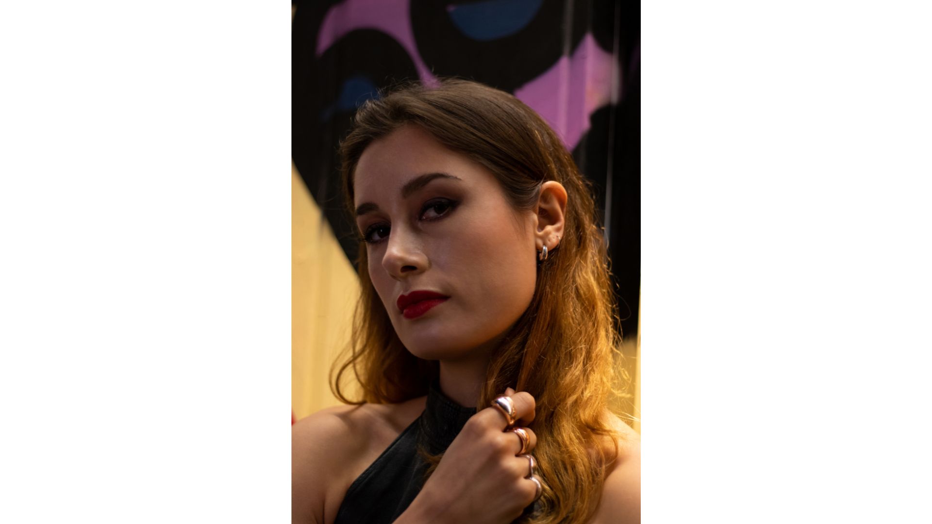 A person with long hair and red lipstick
Description automatically generated