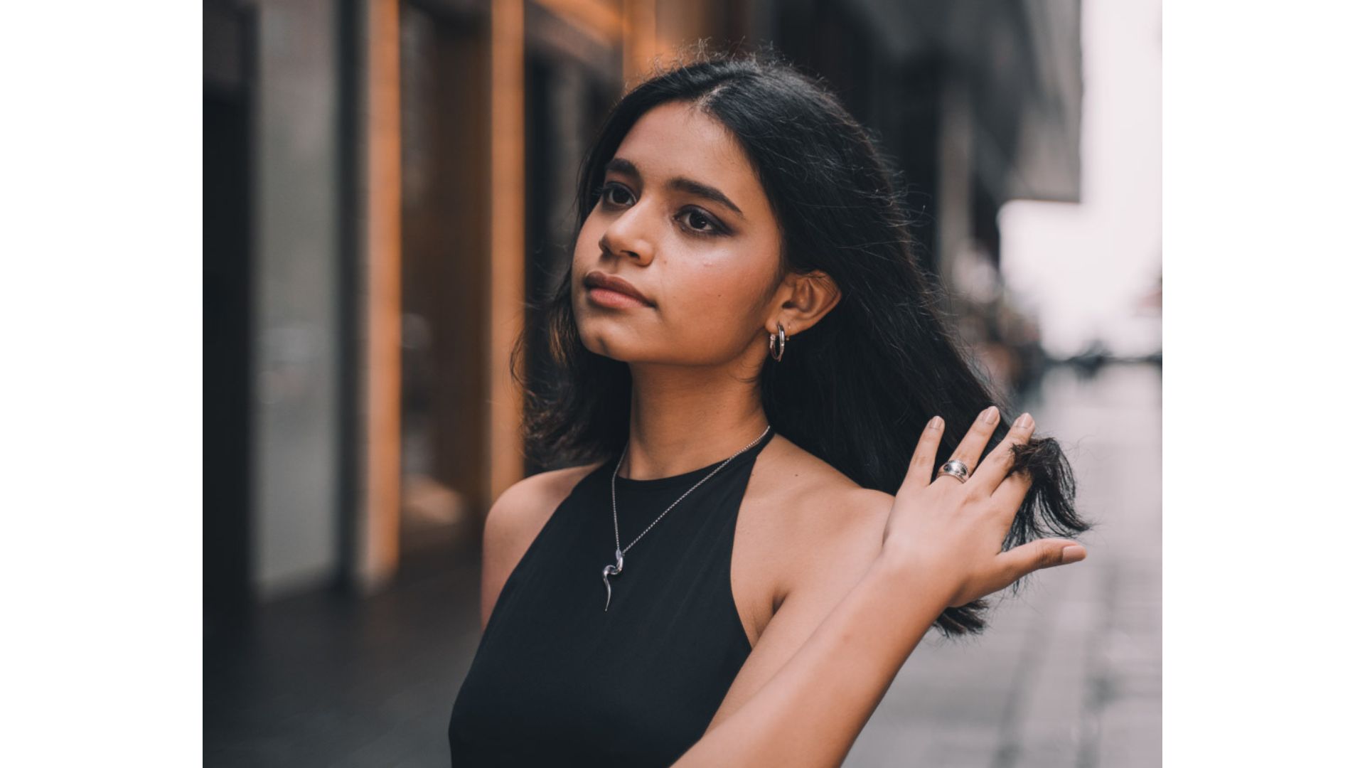 A person in a black dress
Description automatically generated