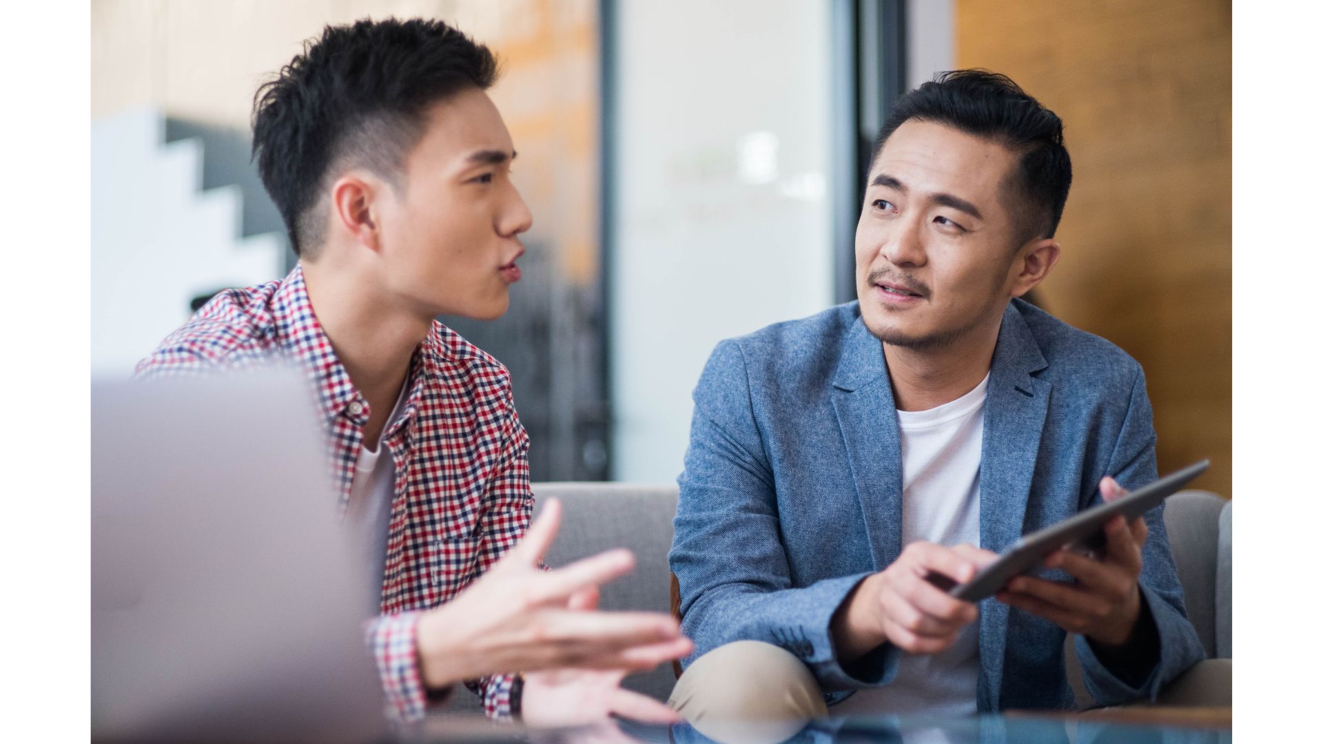 A group of men sitting at a tableundefinedundefinedundefinedundefinedDescription automatically generated