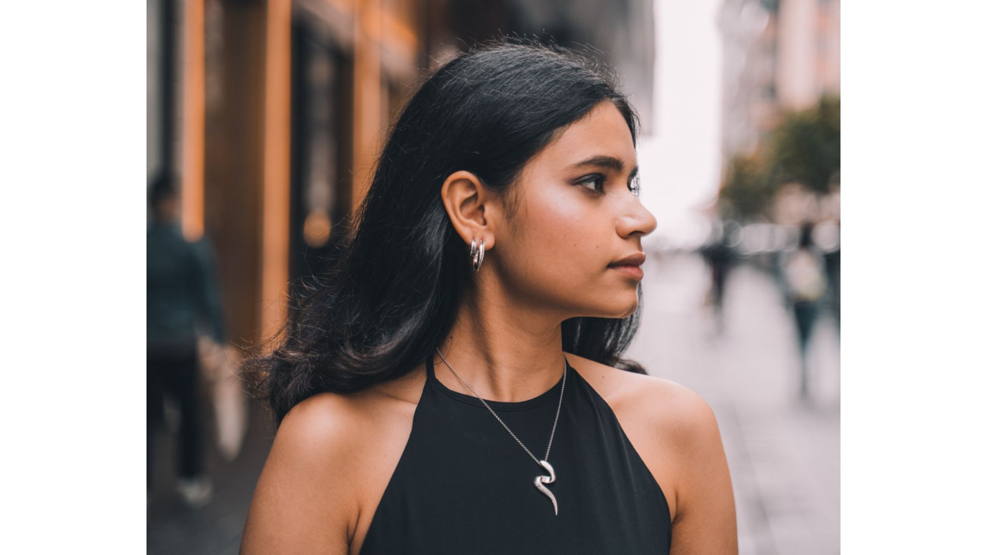 A person in a black dress
Description automatically generated