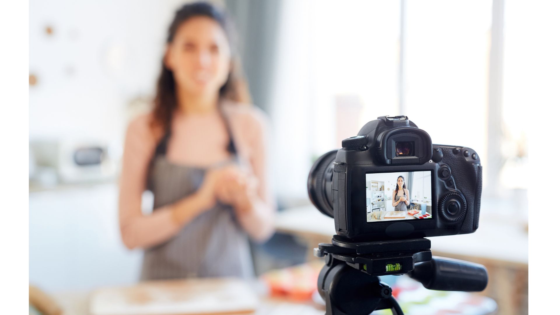 A person in an apron behind a cameraundefinedundefinedAI-generated content may be incorrect.
