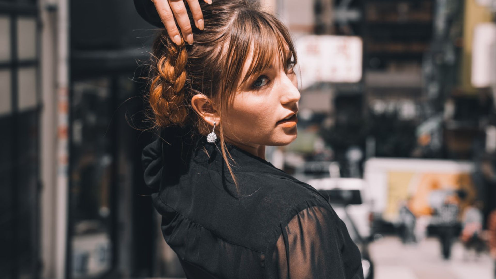 A person with her hand on her hair

AI-generated content may be incorrect.