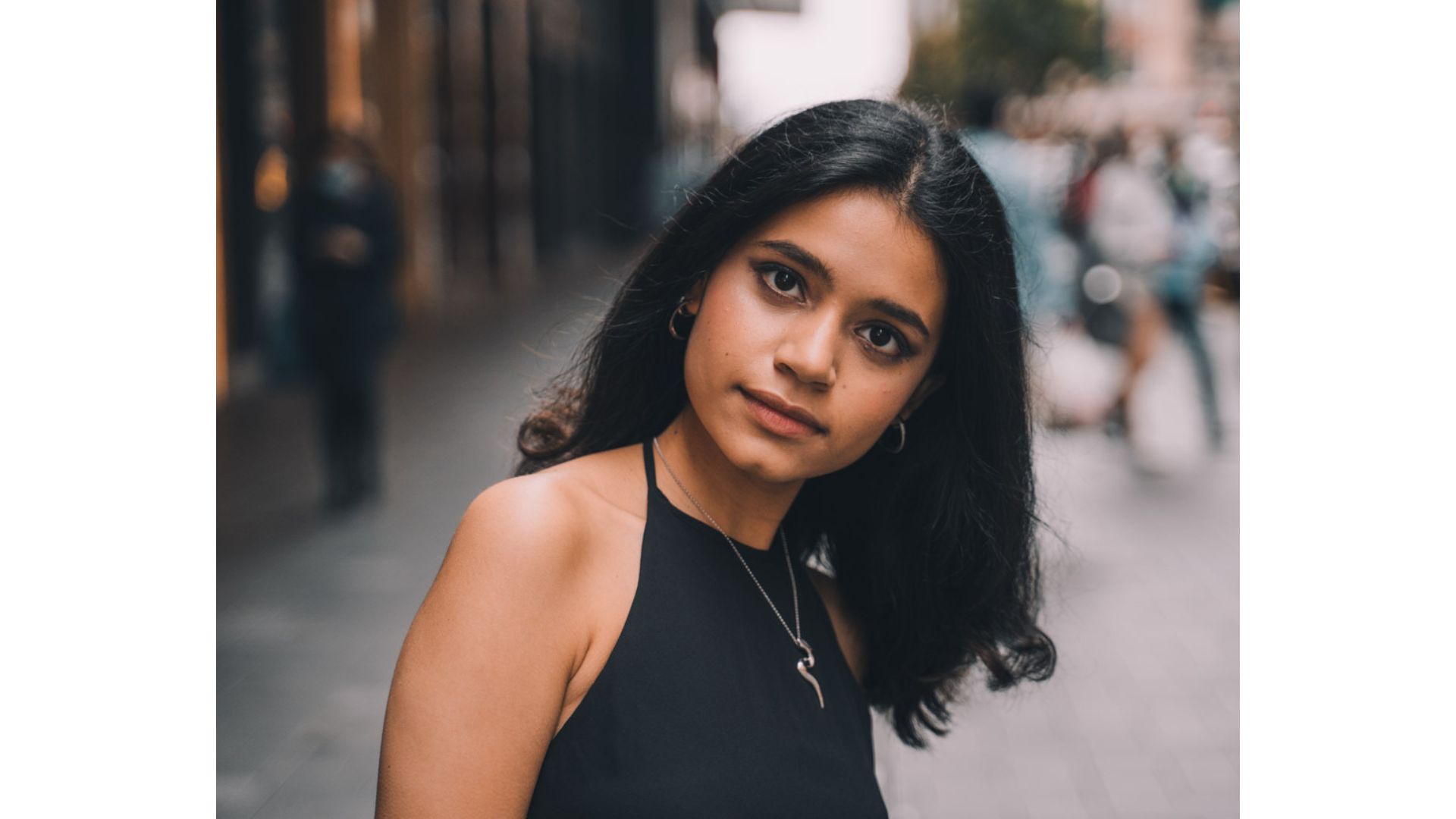 A person with long black hair
Description automatically generated