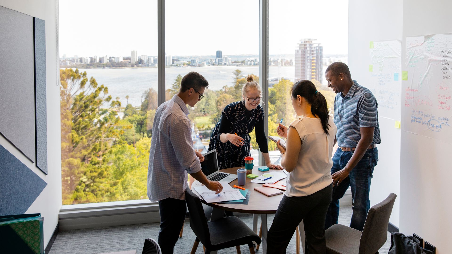 A group of people standing around a table
AI-generated content may be incorrect.