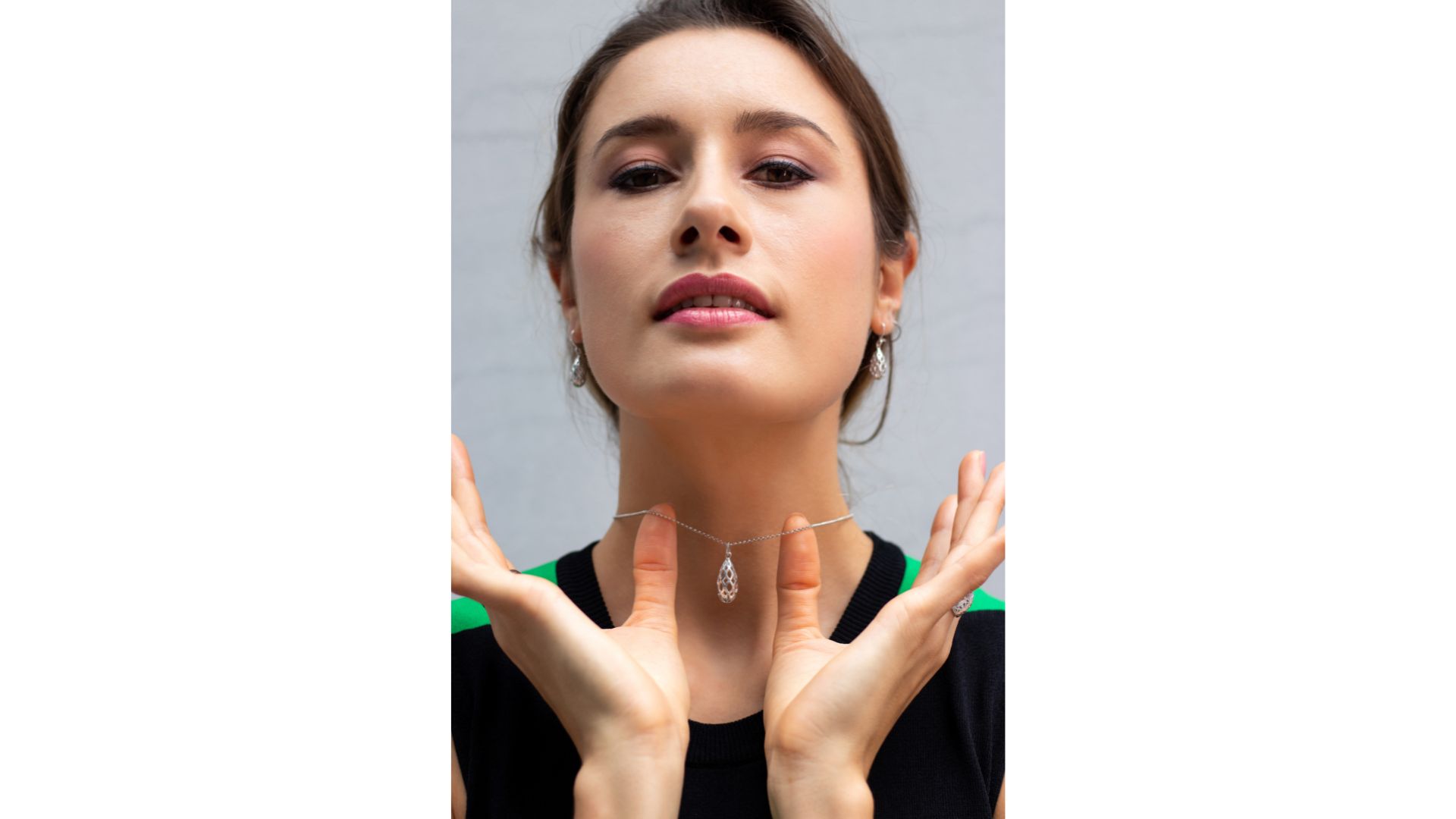 A person with her hands up
Description automatically generated