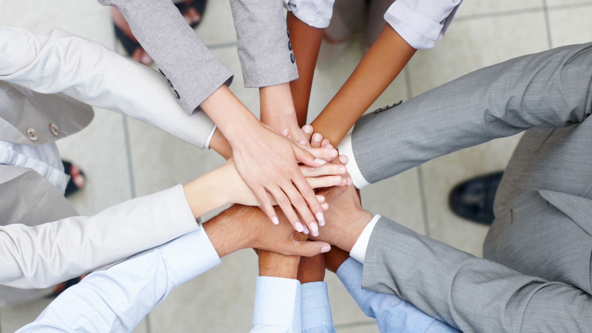 A group of people putting their hands together

AI-generated content may be incorrect.
