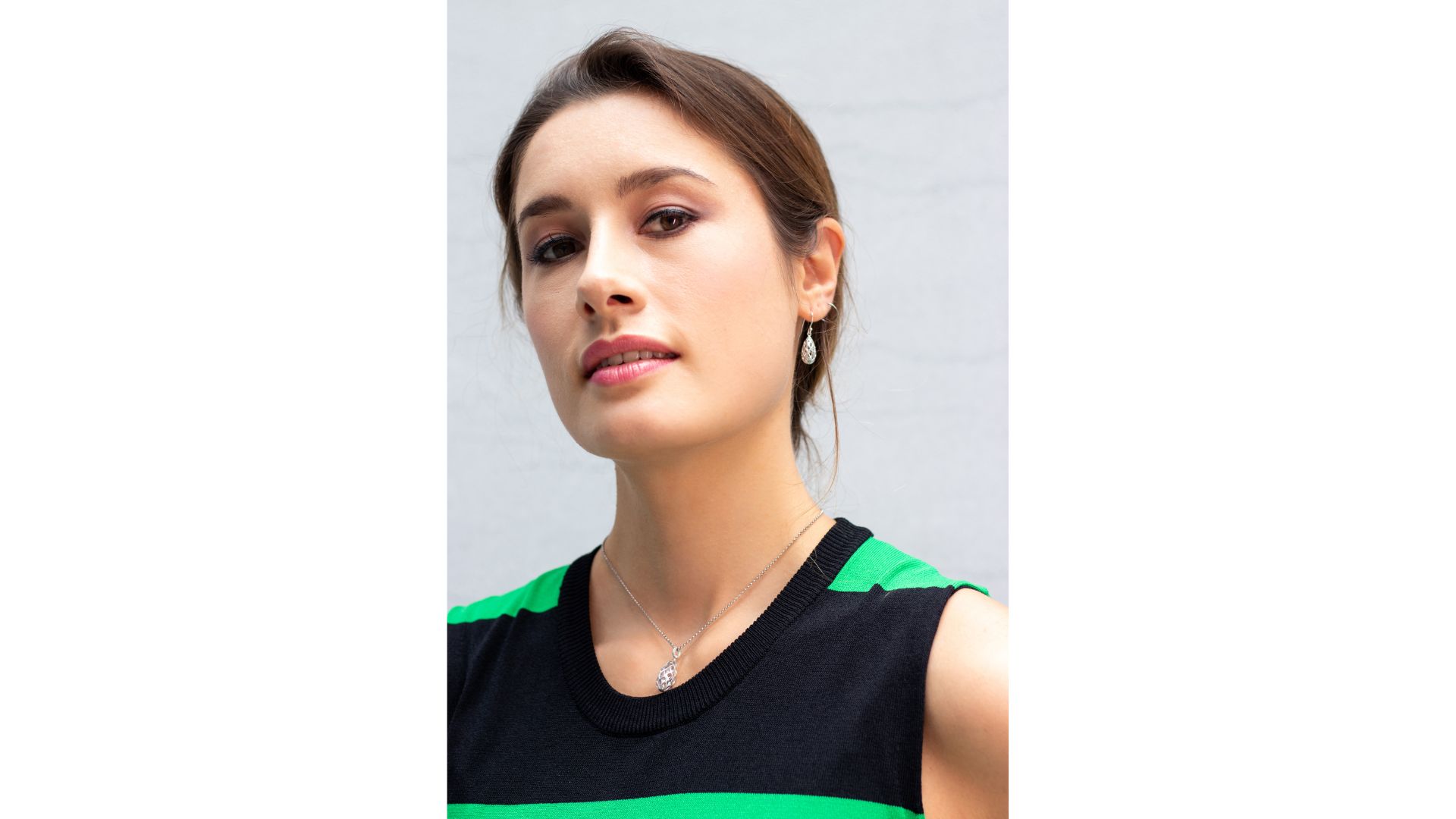 A person in a green and black striped shirt
Description automatically generated