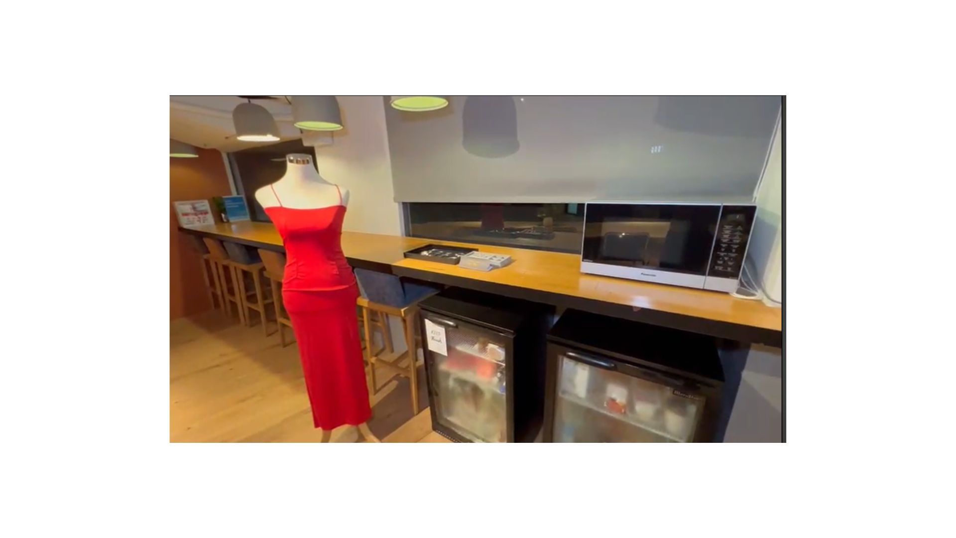 A mannequin in a red dress
Description automatically generated